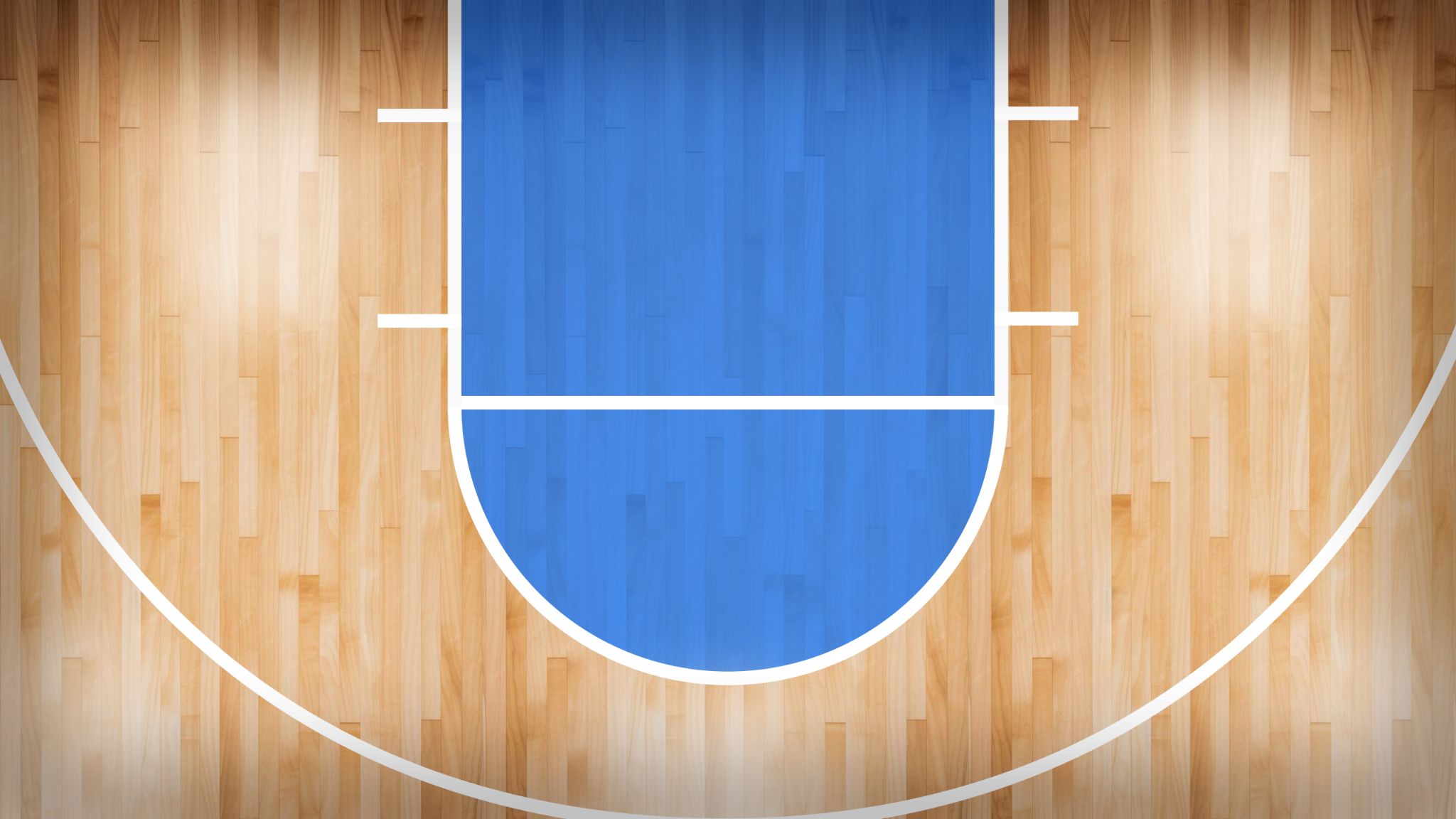 The Pro's arena court with a blue painted key on polished wood.